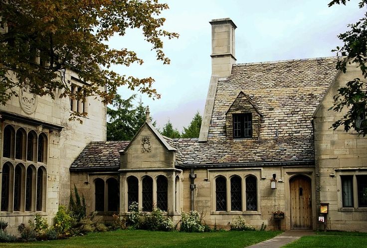 an old stone house with a clock tower