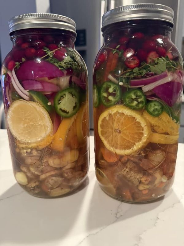 two jars filled with food sitting on top of a counter