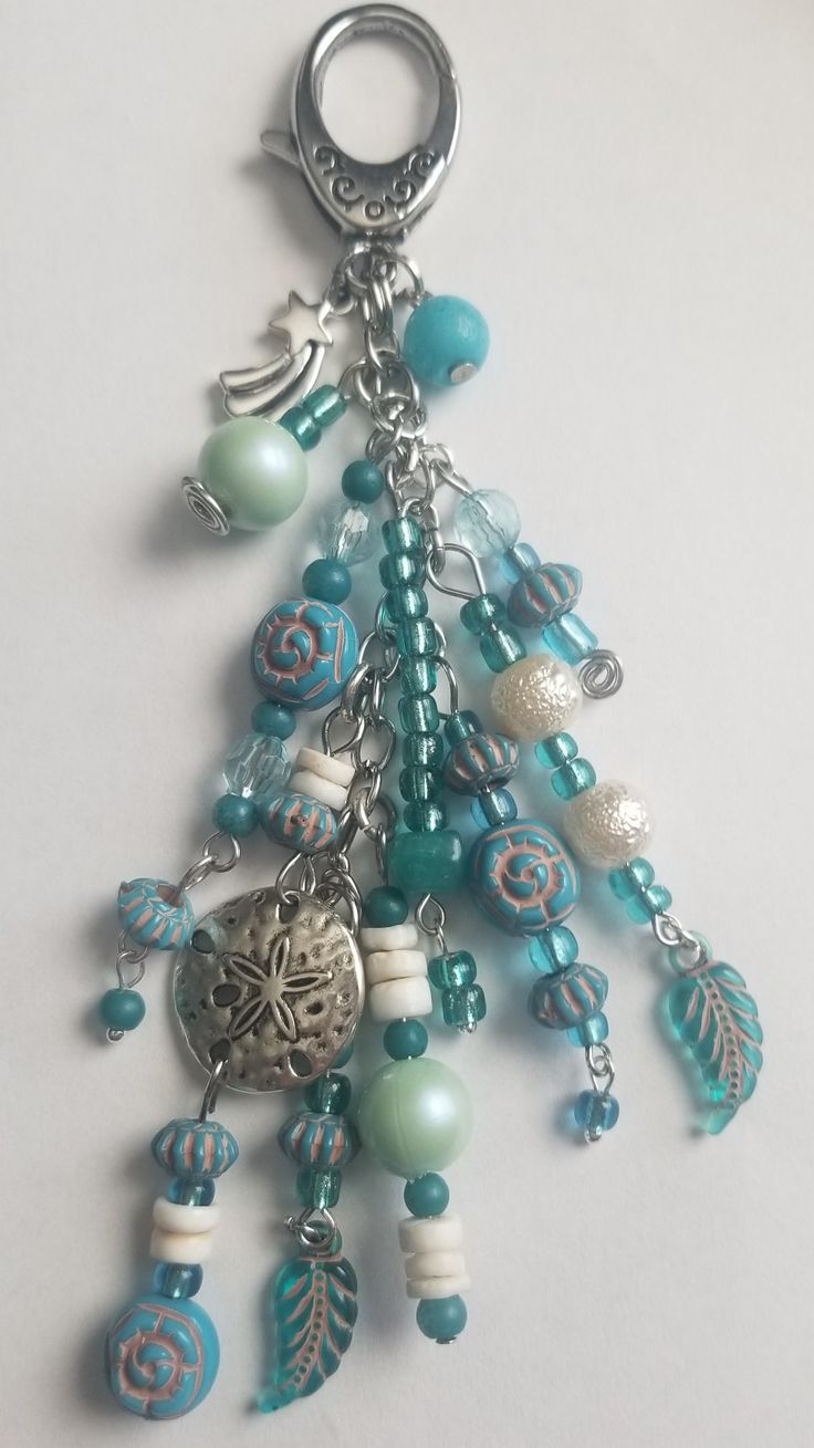 a close up of a key chain with beads and charms