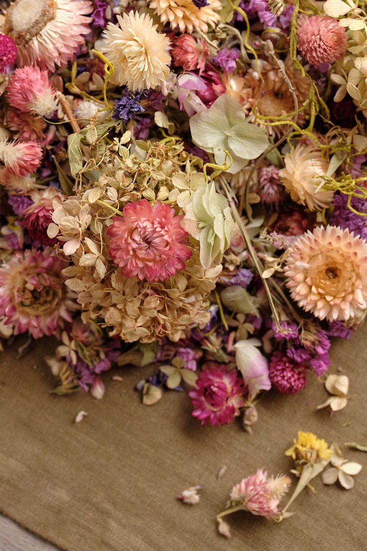 a bunch of dried flowers sitting on top of a table