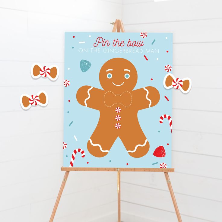 a gingerbread man is on the easel next to some candy canes