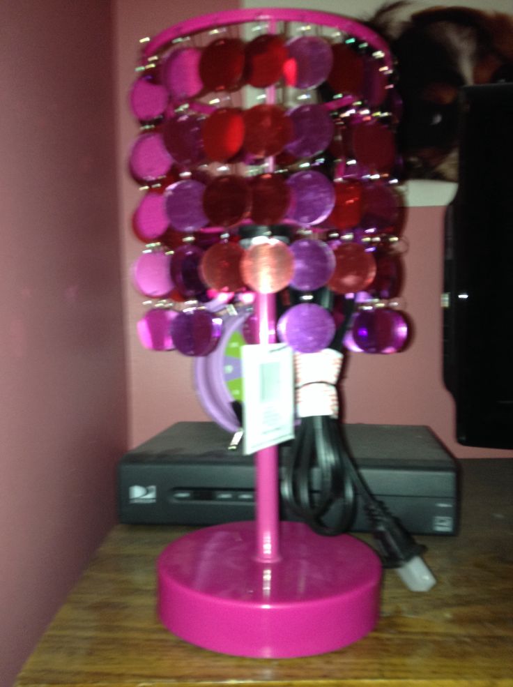 a pink table with a purple lamp on it