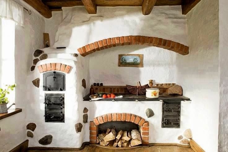 an old fashioned kitchen with brick ovens and wood flooring in the middle of it