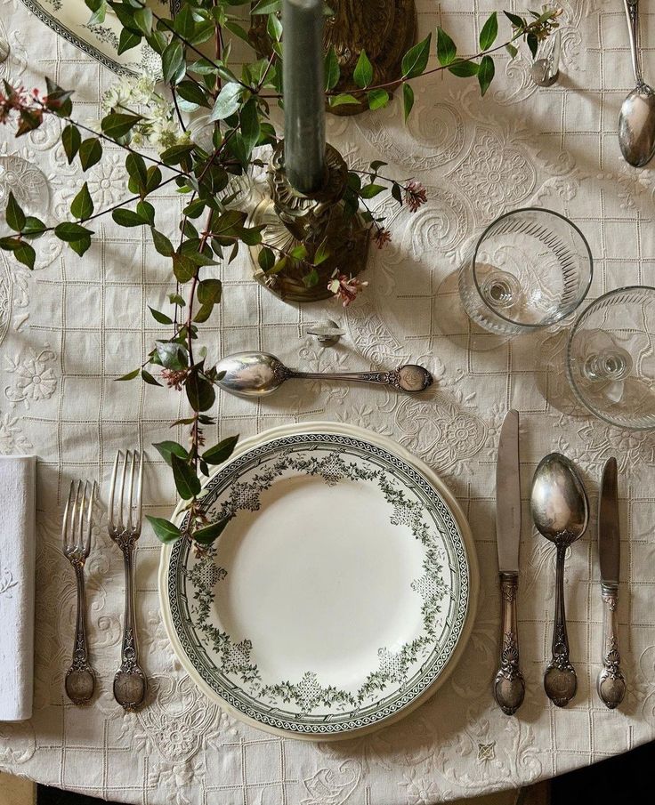 the table is set with silverware and flowers