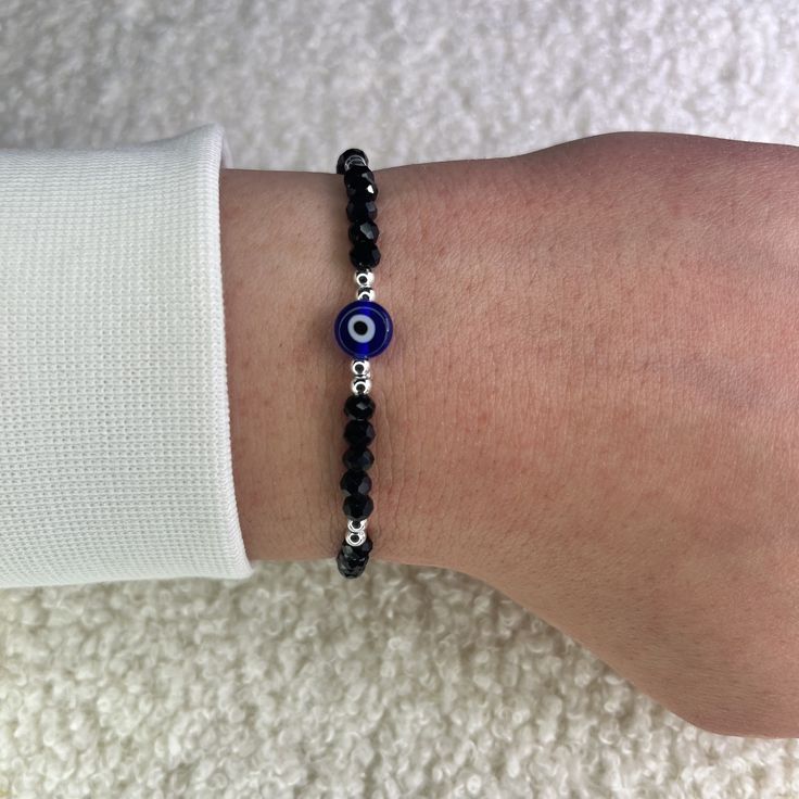 Protect yourself from negativity with our black evil eye bead bracelet with silver balls and bring only positive vibes into your life. Since all of our Nazar protective bracelets with the popular Turkish eye are adjustable in size, they fit children, women and men and are therefore the perfect gift. What are the advantages of our 100% handmade black protective amulet? ❤️ Unique Hamsa or Boncuk design. ❤️ Uniquely braided and therefore suitable for every wrist. ❤️ Many color variations and therefore suitable for every outfit. How does it protect children, women and men? 🧿 Built-in Nazar amulet in the style of the Greek eye. 🧿 Reflective crystal balls in a bling bling look. 🧿 Daily reminder to manifest positive things for yourself. What materials are used? 💎 Polyester for a comfortable w Man Bracelet Beads, Protective Bracelets, Black Evil Eye Bracelet, Only Positive Vibes, Evil Eye Bracelet Silver, Nazar Bracelet, Nazar Amulet, Black Evil Eye, Eye Bead Bracelet