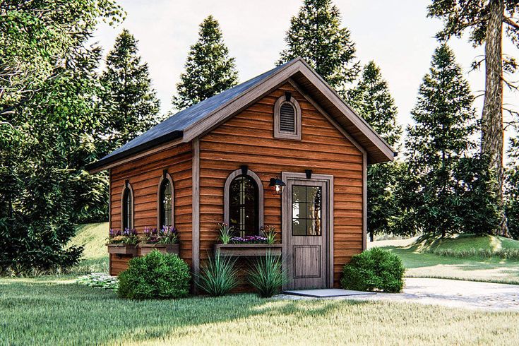 a small wooden cabin sitting in the middle of a lush green field next to trees