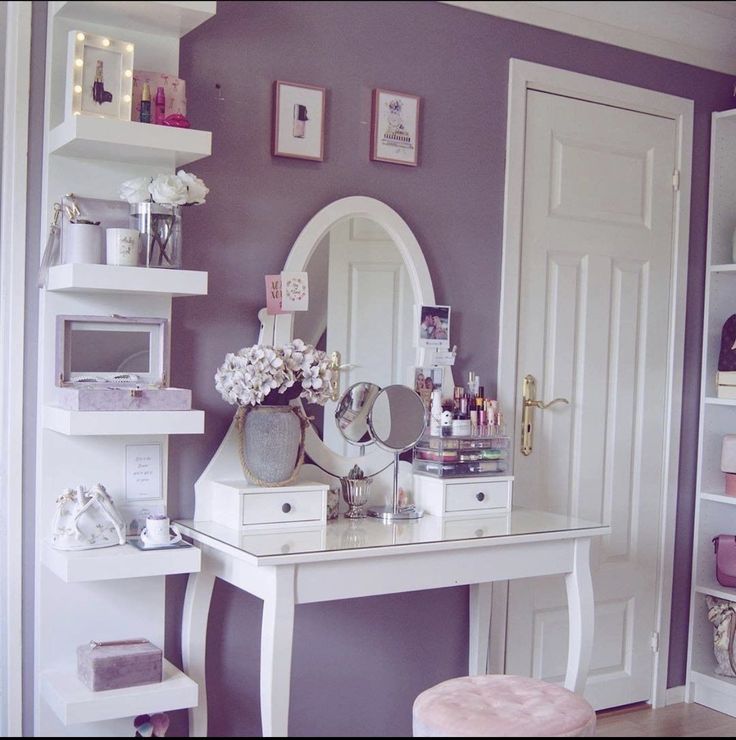 a white desk with a mirror, stool and shelves