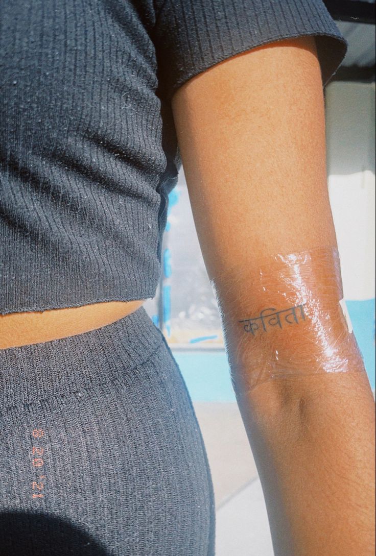 a person with a small tattoo on their arm