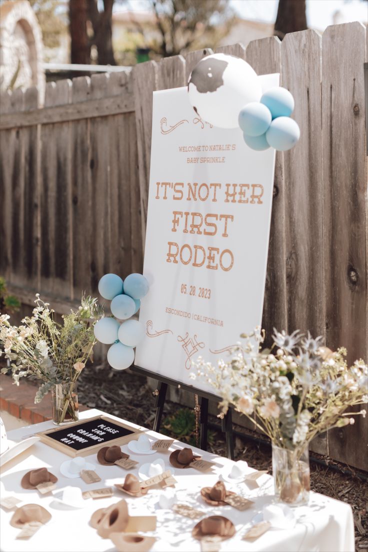 there is a sign that says it's not her first rodeo on the table