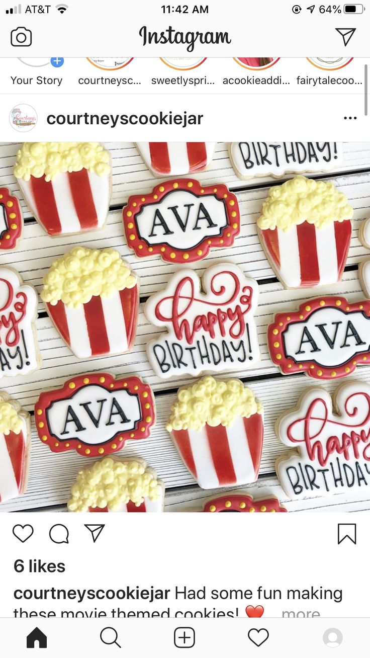 some cookies that are on top of a wooden table with the words happy birthday written in red and white