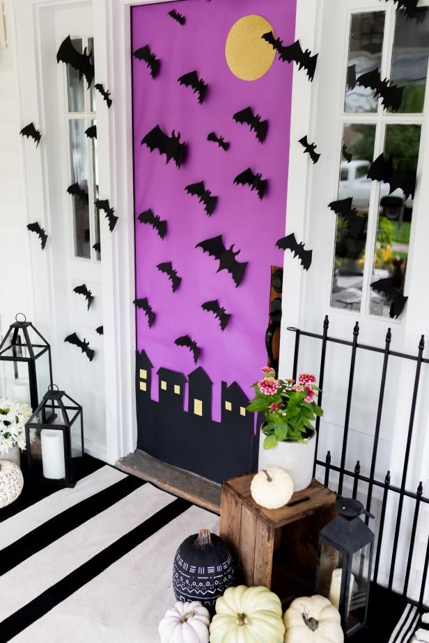 the front door is decorated with bats and pumpkins