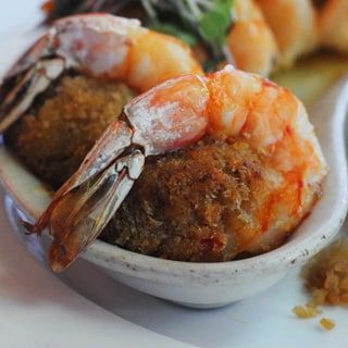 a plate topped with shrimp and other food items