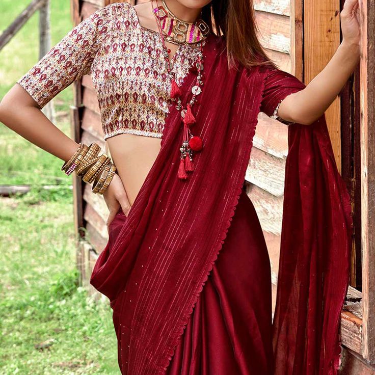 Maroon colored saree is made from chiffon fabric which is highlighted with beautiful Swarovski Work as shown. comes along with unstitched satin blouse which you can customise as per your design/style. Occasion - You can wear this saree for Party, outing and get-together. Note:- the actual product may differ slightly in color and design from the one illustrated in the images when compared with computer or mobile screen. Measurements: Saree : Chiffon : 5.5 Mtrs Blouse : Chiffon : 0.8 Mtr Material: Chiffon Stitch Type: Unstitched Country of Origin: India Care Guide: Dry Clean Art Silk Pre-draped Saree With Mirror Work, Festive Blouse With Sheer Dupatta For Eid, Festive Dola Silk Blouse With Sheer Dupatta, Art Silk Blouse Piece With Sheer Dupatta, Designer Sheer Dupatta Blouse For Navratri, Traditional Georgette Blouse With Cutdana, Designer Blouse With Sheer Dupatta For Navratri, Traditional Drape Blouse In Georgette With Cutdana, Designer Wear Blouse With Sheer Dupatta For Navratri