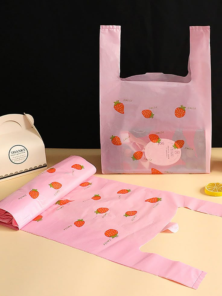 a pink bag sitting on top of a table next to other items