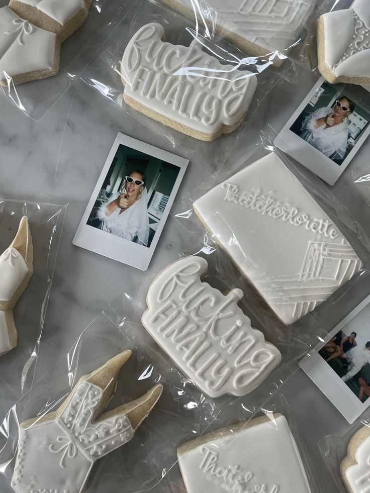 some cookies that have been decorated with pictures and words on them, sitting on a table