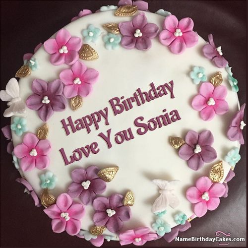 a birthday cake with pink and purple flowers on it that says happy birthday any name here