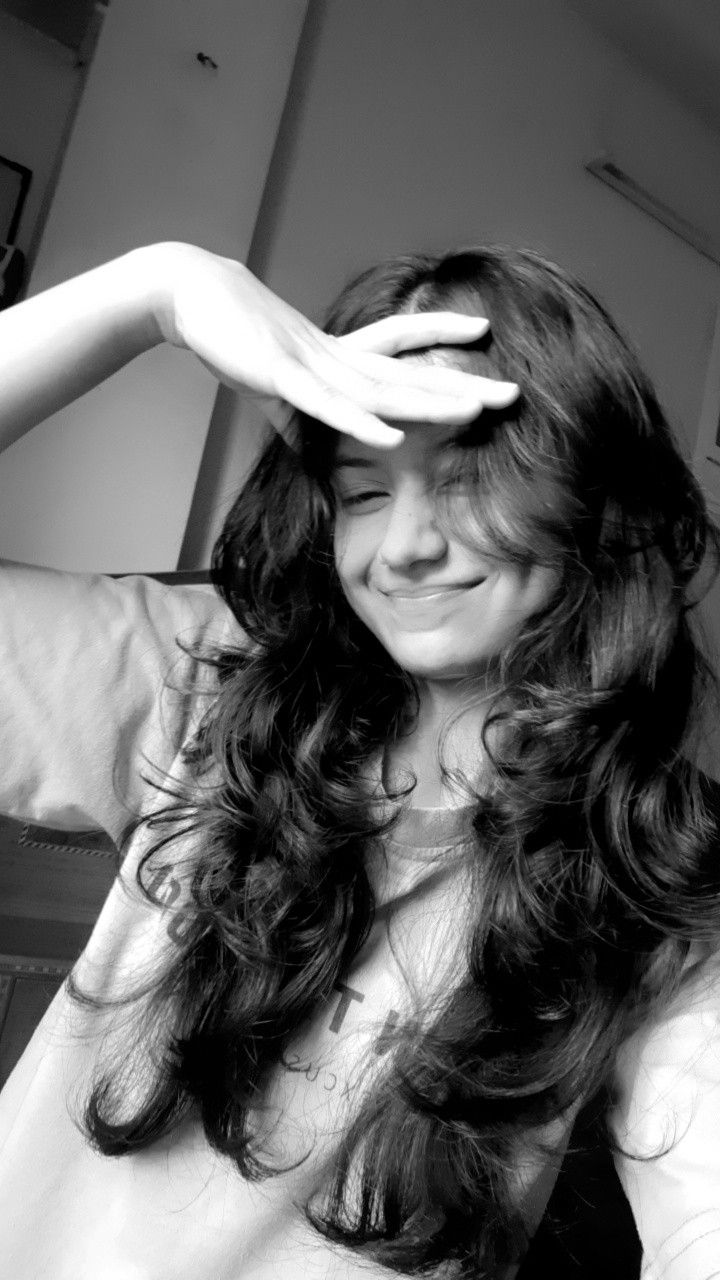 black and white photograph of a woman brushing her hair