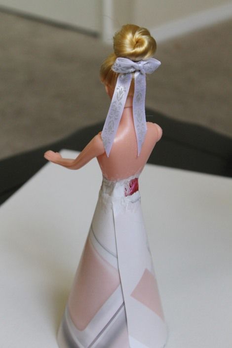 there is a small figurine that has a dress on it's head