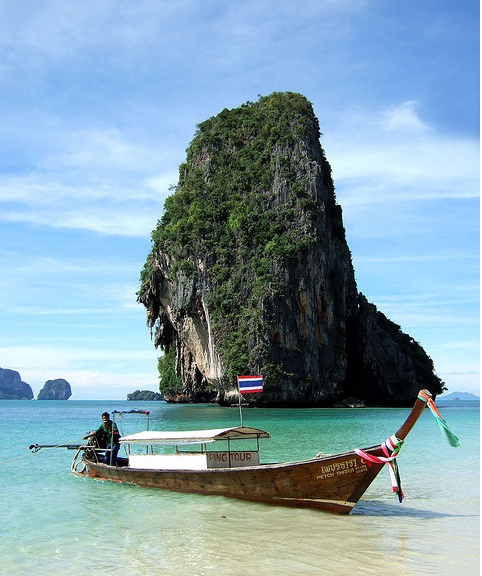 two boats in the water near an island