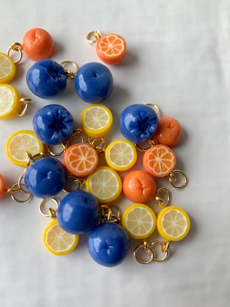 a bunch of oranges and lemons on a white surface