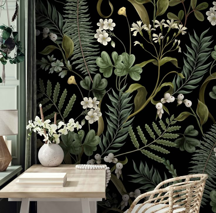 the wallpaper in this room is decorated with green leaves and white flowers on black