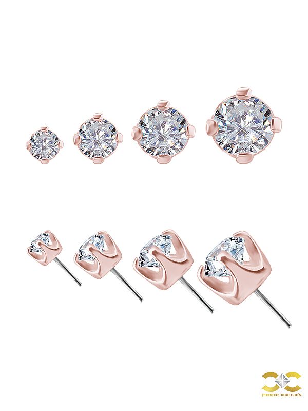 four pairs of stud earrings with cubics on each side and one diamond in the middle