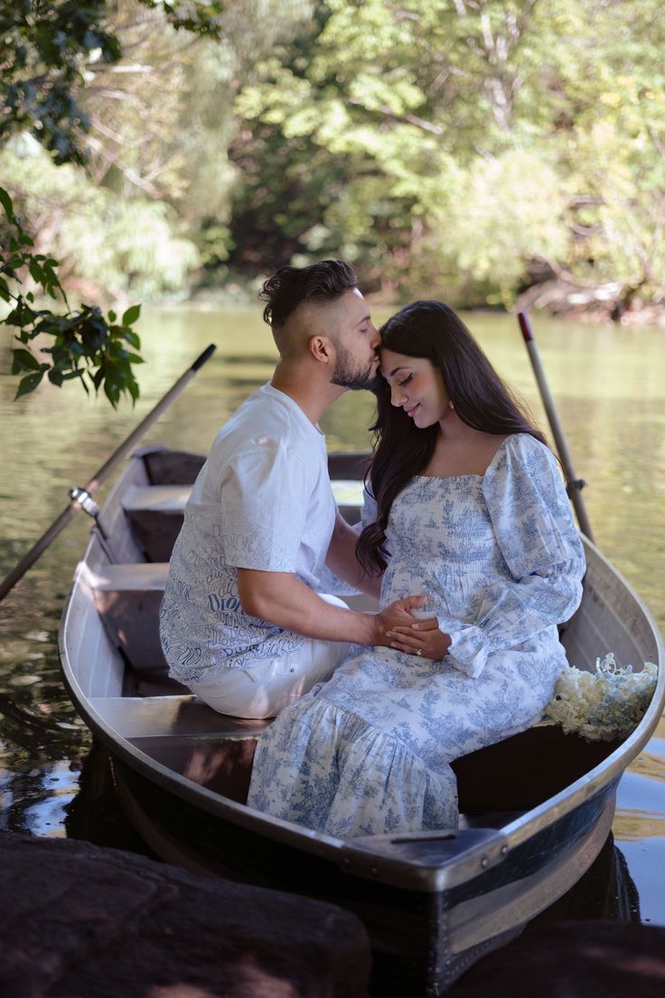 a man and woman are sitting in a boat