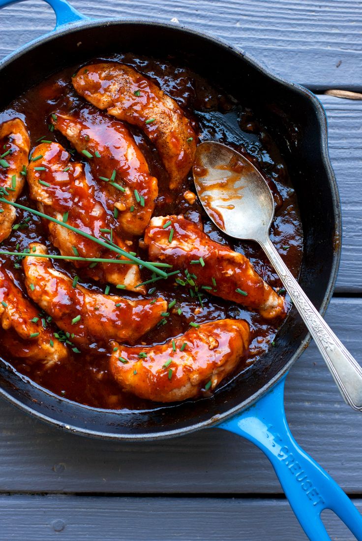 a pan filled with chicken wings covered in sauce