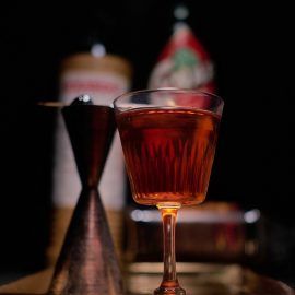 a glass filled with liquid sitting on top of a table