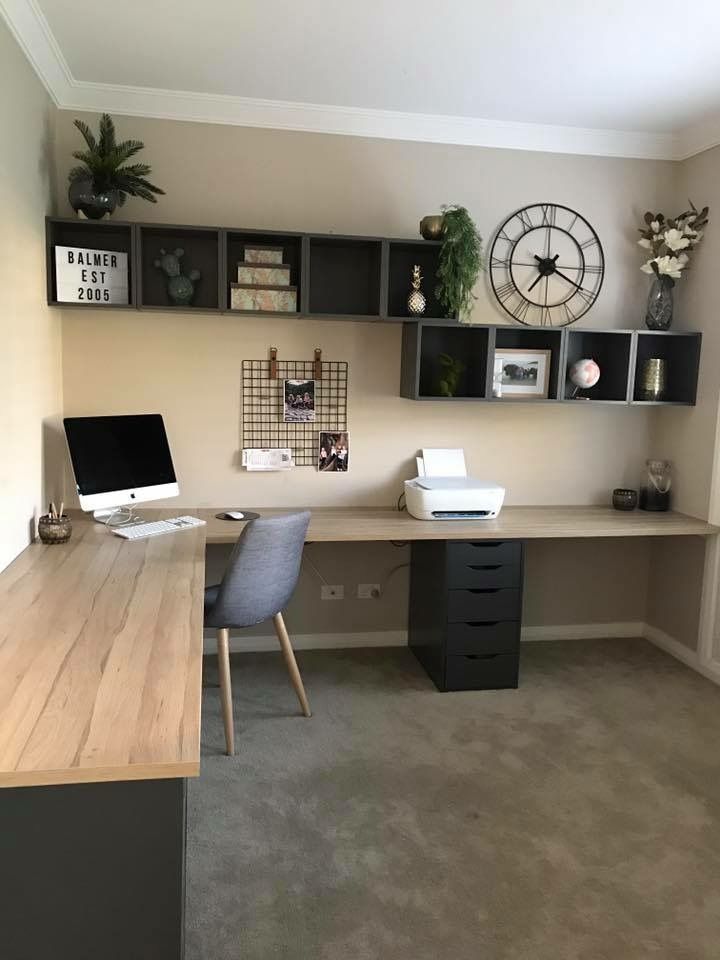 a home office with desk, computer and shelves