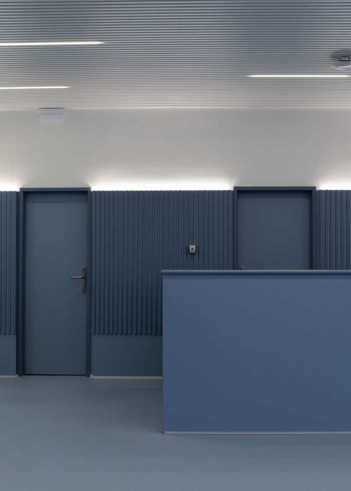 an empty room with blue walls and doors