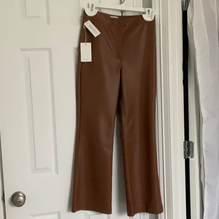 Aritzia Wilfred Adele High Rise Kick Flare Leather Look Pants Look And Feel So Much Like Real Leather You Would Never Know They Aren’t. They Are In The Cognac Shade ( True Colour Shown On Model Photos.) They Have A Front Zip Popper And Button Fly And Two Darts At The Back For A Tailored Fit Into The Waist . Brand New And Hung Up With Cottonwool Pads So Hanger Doesn’t Leave Marks On Waistband. Giftable Condition. Fitted Leather Wide-leg Pants, Elegant Brown Leather Pants Full Length, Elegant Brown Leather Pants For Spring, Elegant Brown Full-length Leather Pants, Elegant Full-length Brown Leather Pants, Elegant Full Length Brown Leather Pants, Brown Leather Spring Pants Full Length, Brown Leather Full-length Pants For Spring, Brown Full-length Leather Pants For Spring