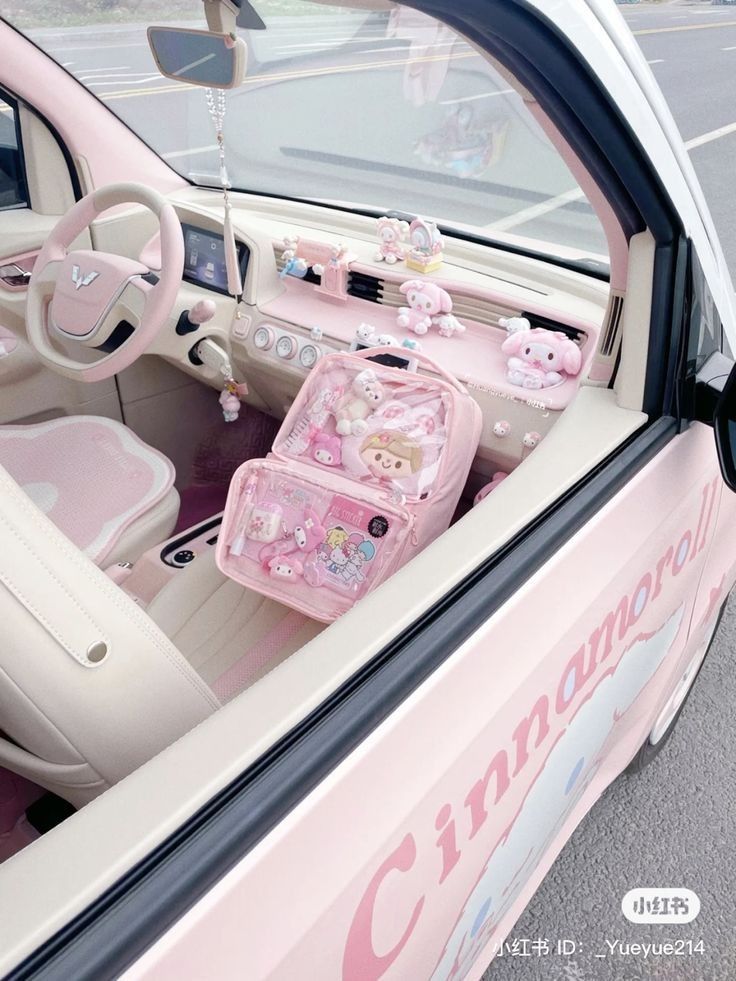 the interior of a pink car with hello kitty decorations