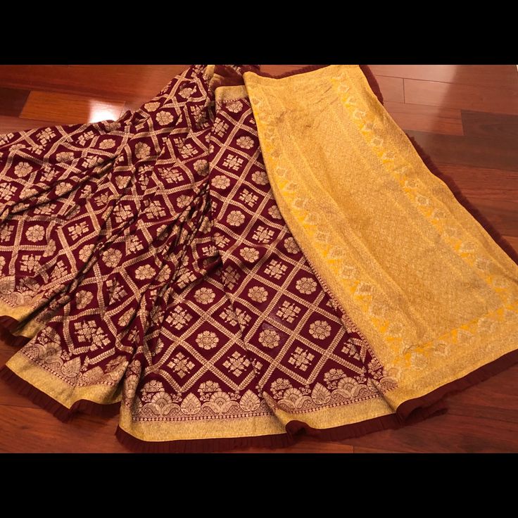 Pure Maroon Georgette Banarasi Saree With Latest Designer Frills On The Saree . Comes With Yellow Unstitched Blouse Piece. Ready To Ship Yellow Silk Sharara With Dupatta, Yellow Silk Sharara For Festive Occasions, Traditional Yellow Dola Silk Pre-draped Saree, Yellow Silk Sets For Navratri, Yellow Silk Sets With Dupatta, Yellow Silk Sharara For Navratri, Yellow Dola Silk Choli For Puja, Yellow Silk Salwar Kameez For Navratri, Yellow Pre-draped Festive Saree With Pallu