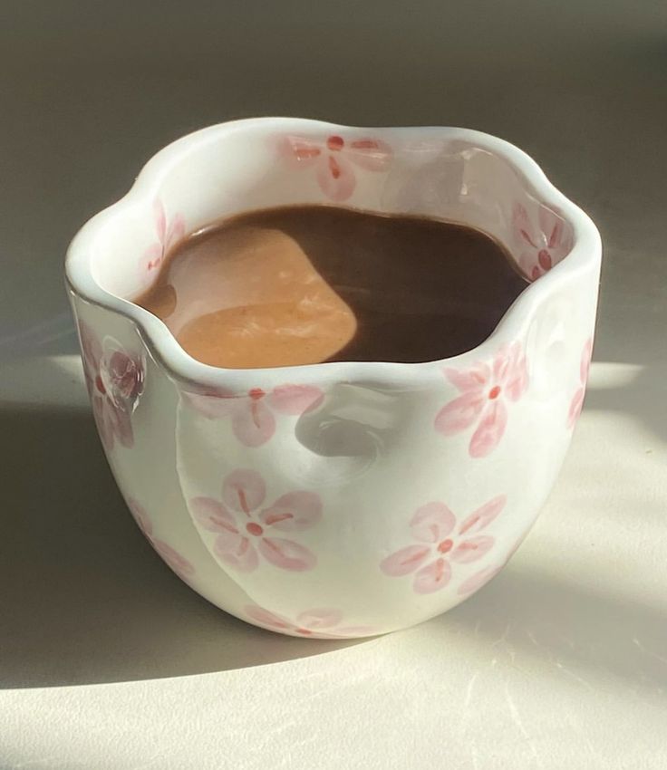 a cup filled with liquid sitting on top of a table