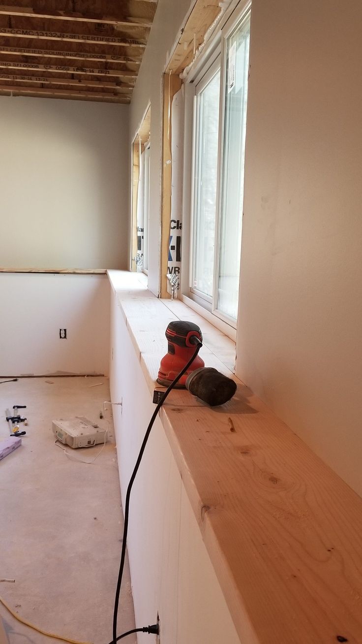 a pair of work boots sitting on top of a counter in a room under construction