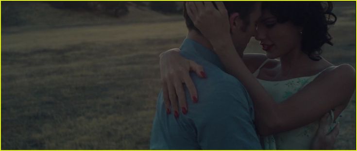 a man and woman embracing each other in a field