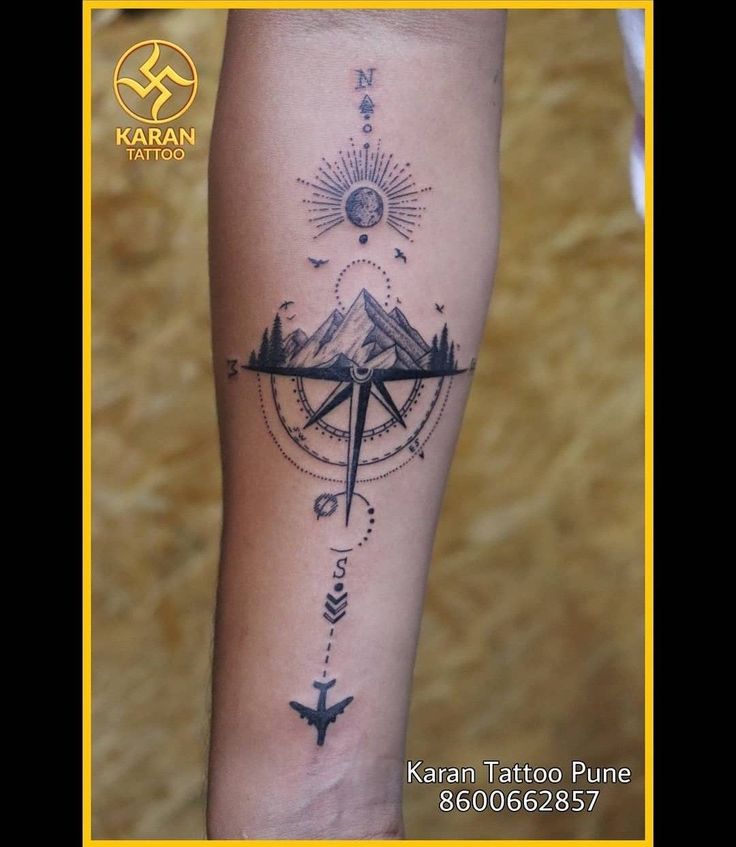 a person with a compass tattoo on their arm