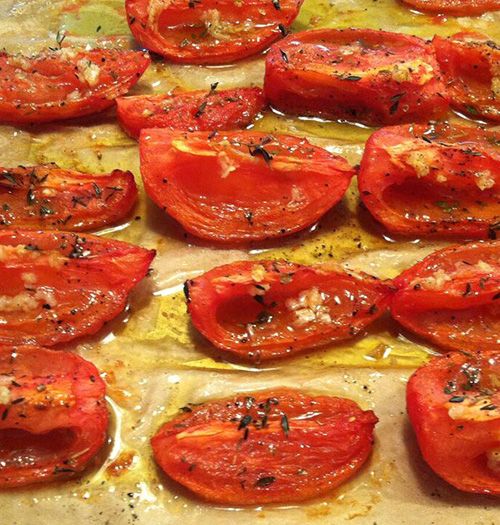 cooked tomatoes on a baking sheet ready to go in the oven