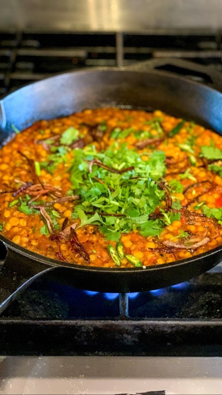 a pan filled with food sitting on top of a stove