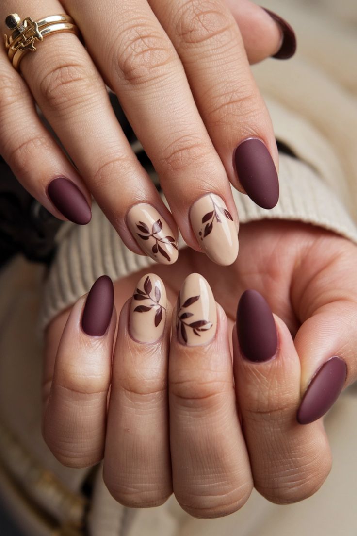 Transform your natural nails this season with stunning fall nail ideas that capture the essence of autumn. Picture a rich burgundy base adorned with delicate gold leaf accents, creating a warm, cozy vibe perfect for any occasion. Let your nails reflect the beauty of falling leaves and crisp air while keeping it chic and natural. Get inspired to embrace the elegance of fall! Leave Nails Fall, Burgundy Nails With Flower Design, Natural Nail Fall Designs, Gold Leaves Nails, Maroon Football Nails, Fall Short Nail Designs Autumn Classy, Autumn Nails With Leaves, Cute Maroon Nails, Easy Natural Nails