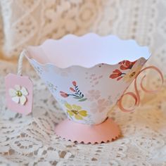 a paper teacup sitting on top of a doily