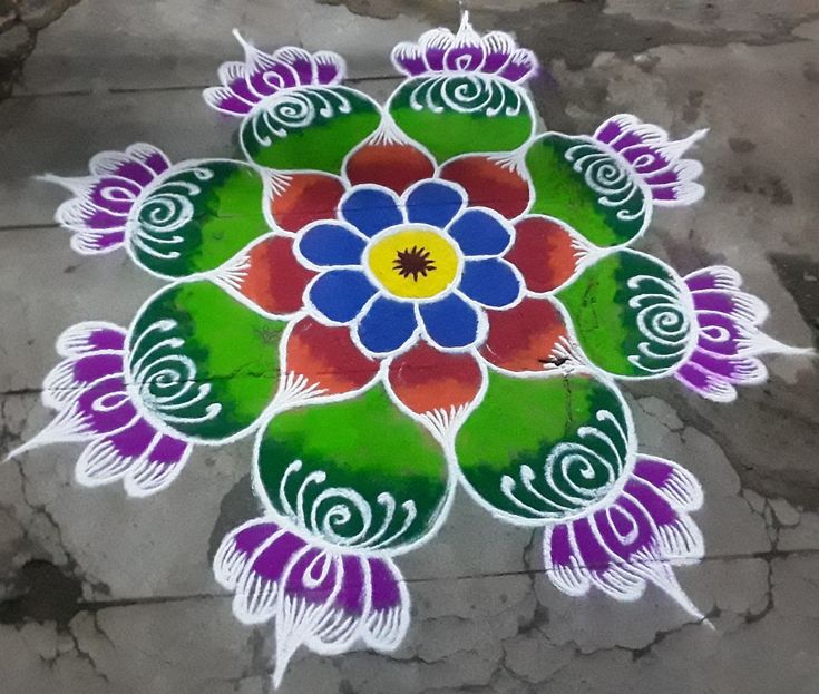 a colorful flower design painted on the ground