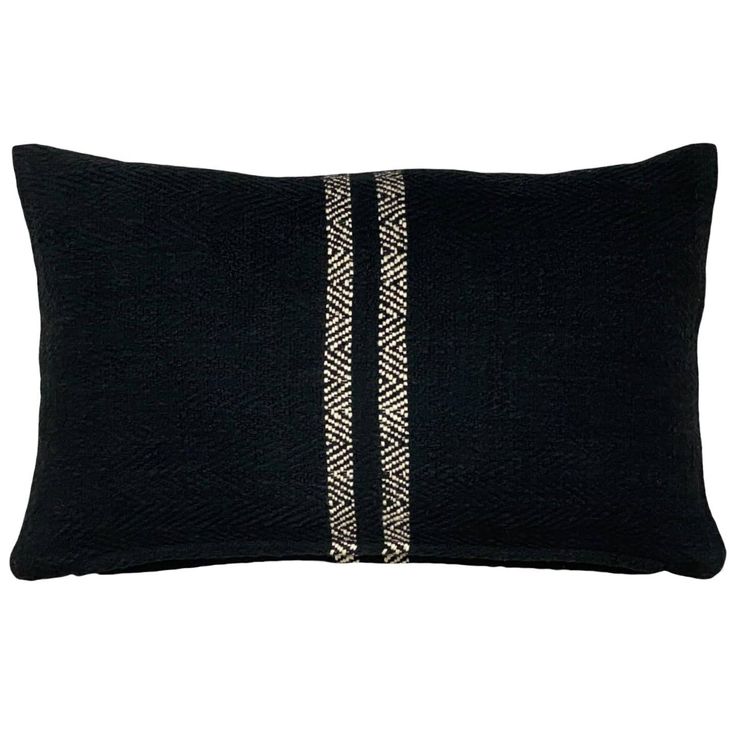 a black pillow with white stripes on it