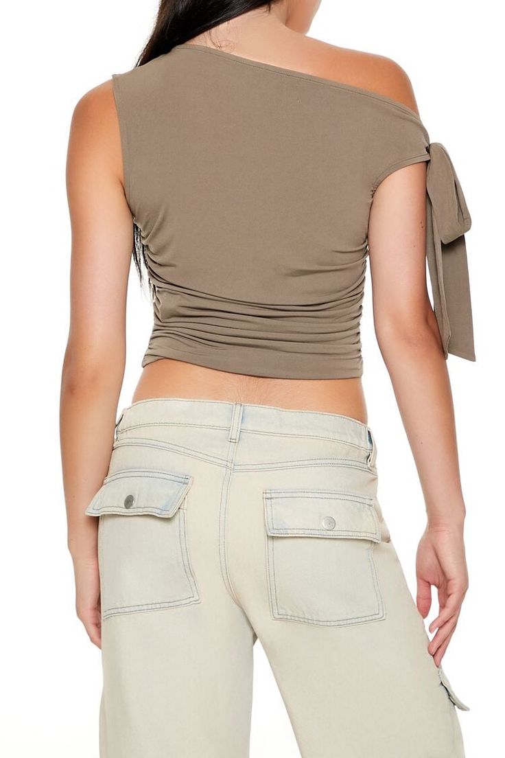 Knit top featuring one - shoulder neckline, self - tie sleeve detail, ruched sides, and cropped hem. | 95% polyester, 5% spandex | Hand wash cold | Model is 5'9" and wearing Small | Ruched One - Shoulder Crop Top Spring Fitted Ruched Crop Top, Fitted Ruched Crop Top For Spring, Spring Ruched Fitted Crop Top, Spring Ruched Crop Top, Casual Fitted Cropped One Shoulder Top, Summer Tops With Ruched Sides And Elastane, Spring Cropped Top With Drawstring, Spring Cropped Tops With Drawstring, Stretch Cropped Top With Drawstring