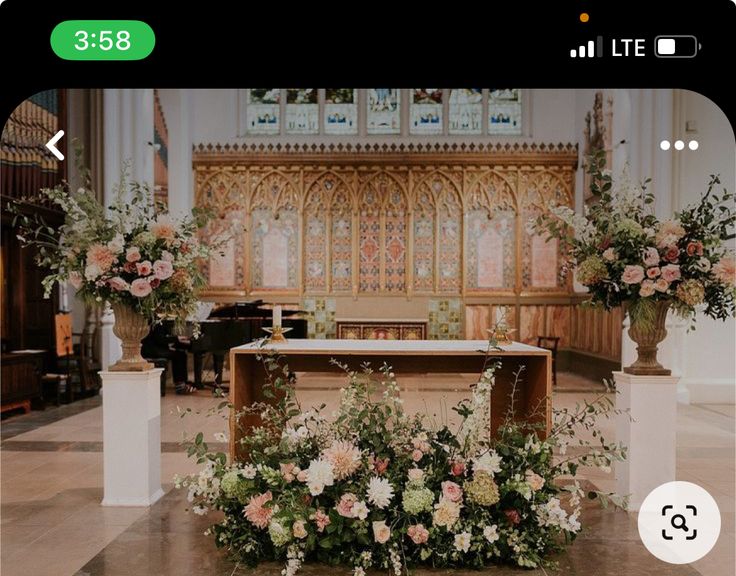 an image of a church with flowers on the alter