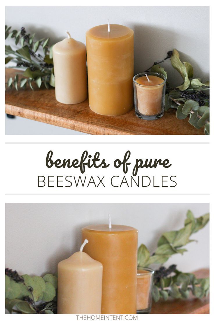 three candles sitting on top of a wooden shelf