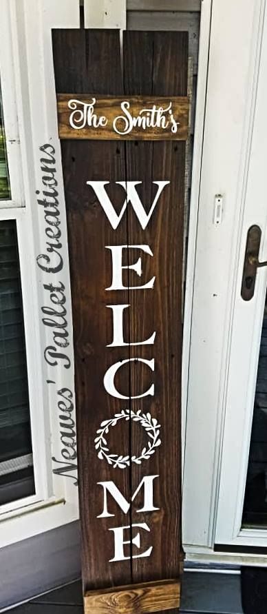 a wooden welcome sign sitting on top of a door