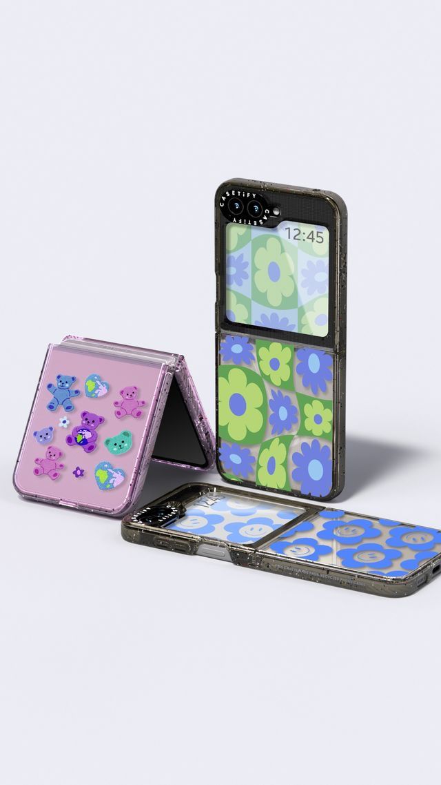 three cell phones with different designs on them, one is pink and the other is blue