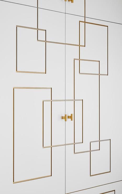 a white wall with gold square and rectangles on it